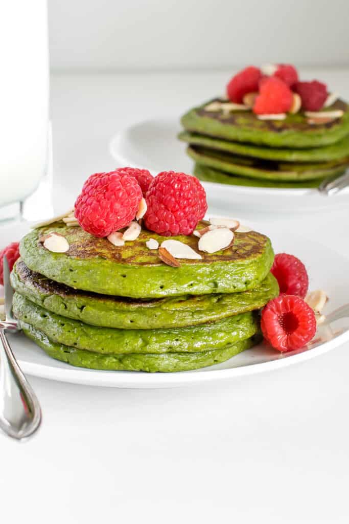 stacked spinach banana pancakes in the serving plates. 