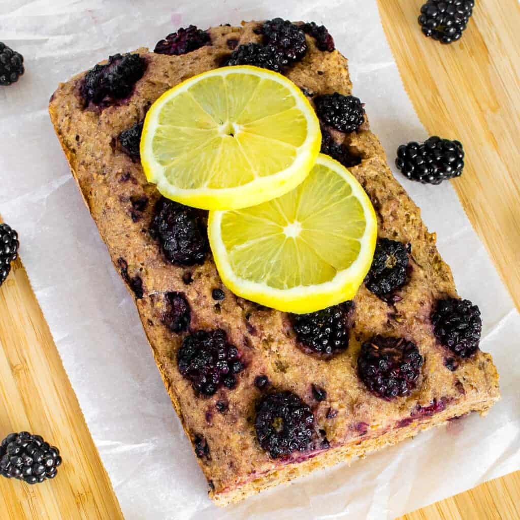 top view of blackberry lemon bread on a wooden board. 