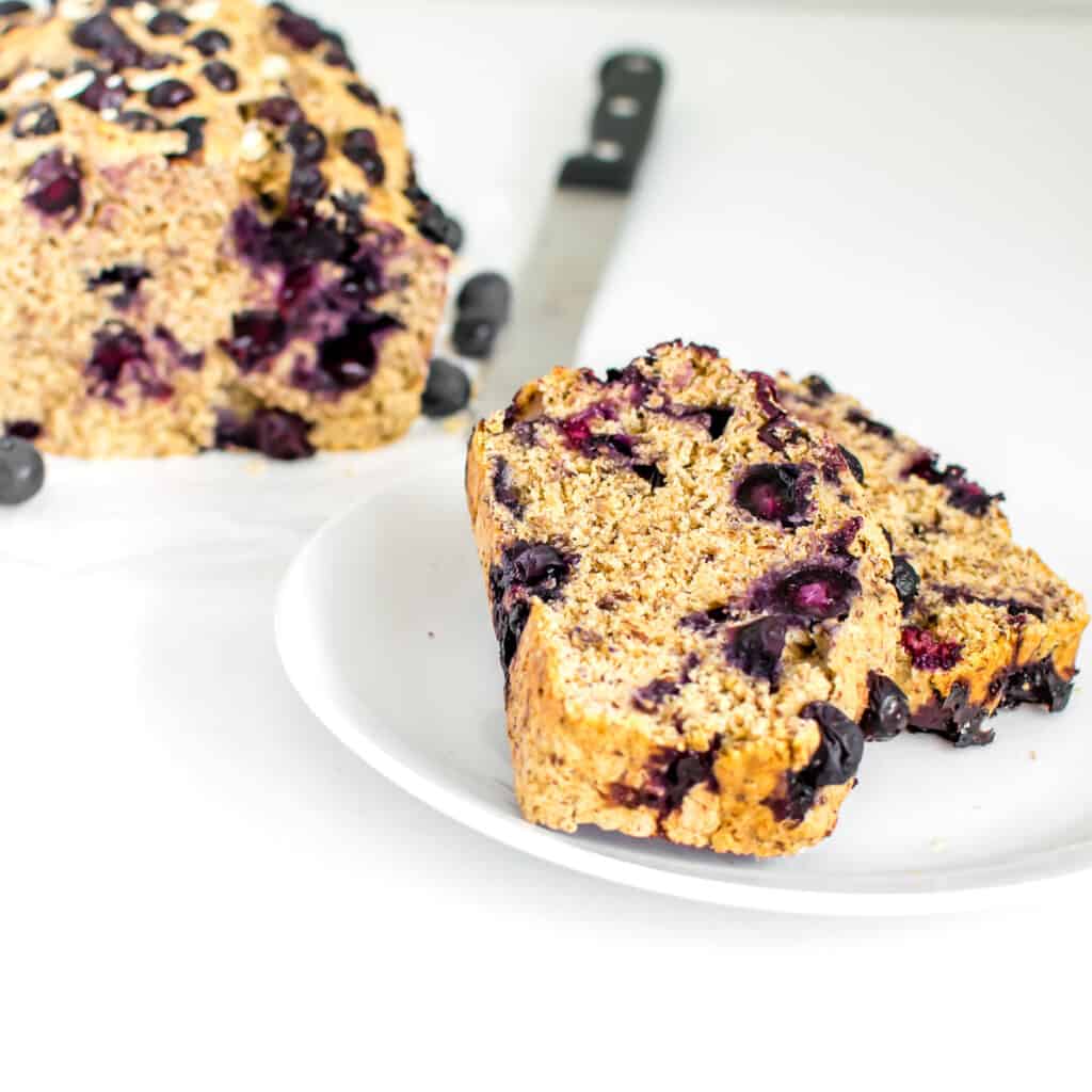 slices of vegan blueberry bread served on a plate. 