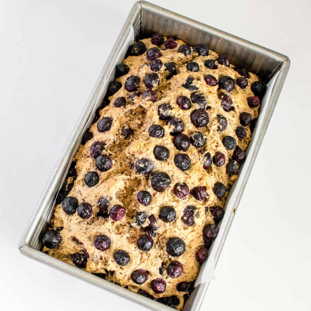fresh baked vegan blueberry bread in the loaf pan.