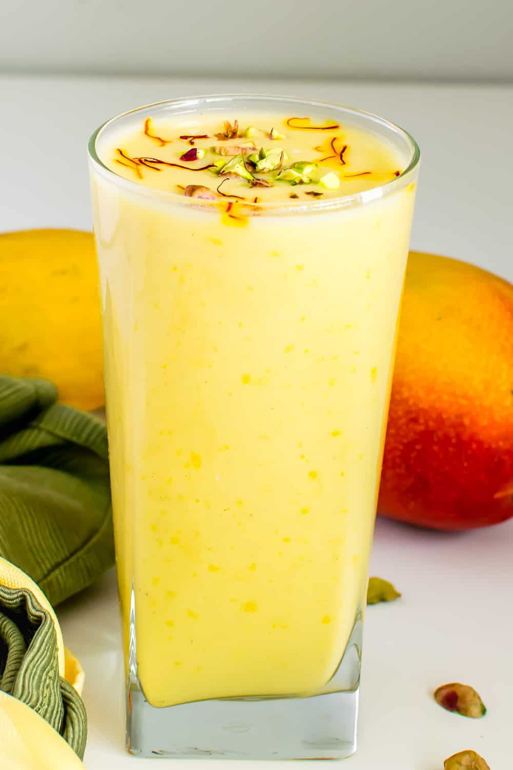 a tall glass filled with vegan mango lassi.