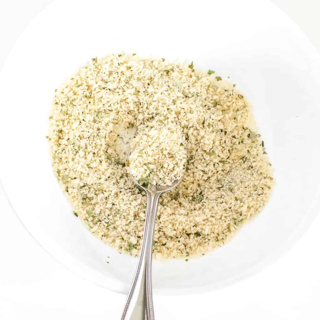 panko tossed in with herbs in a mixing bowl. 