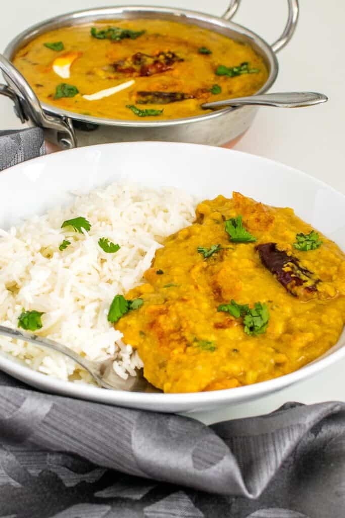 a front view of dal tadka served with rice. 