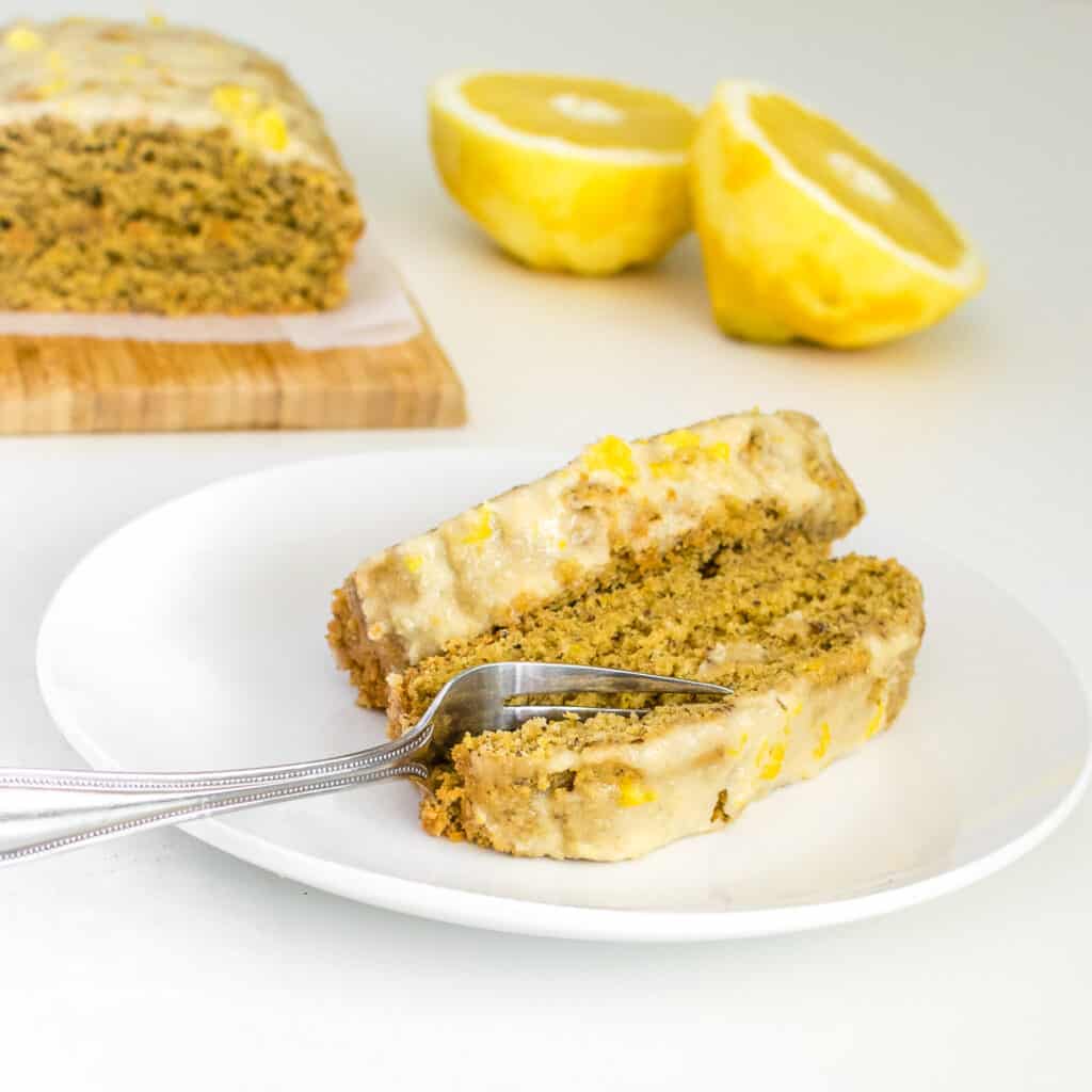 a fork digging into the slices of vegan lemon cake. 