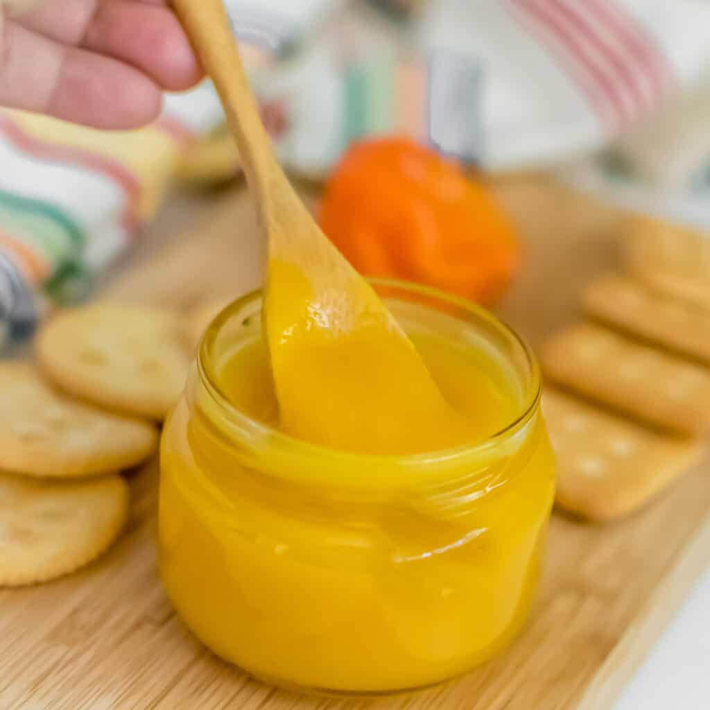 a spoon digging into pineapple habanero sauce.