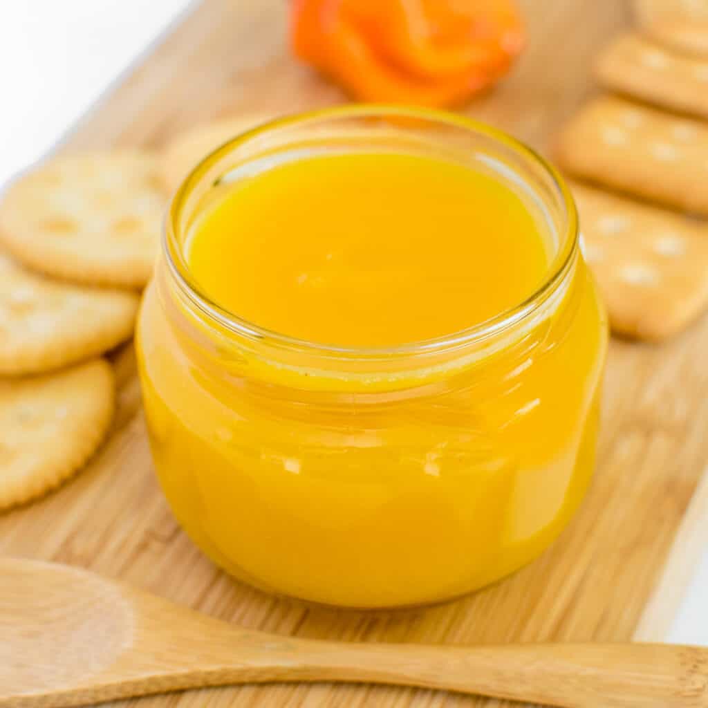 a front view of pineapple habanero sauce in a glass jar.