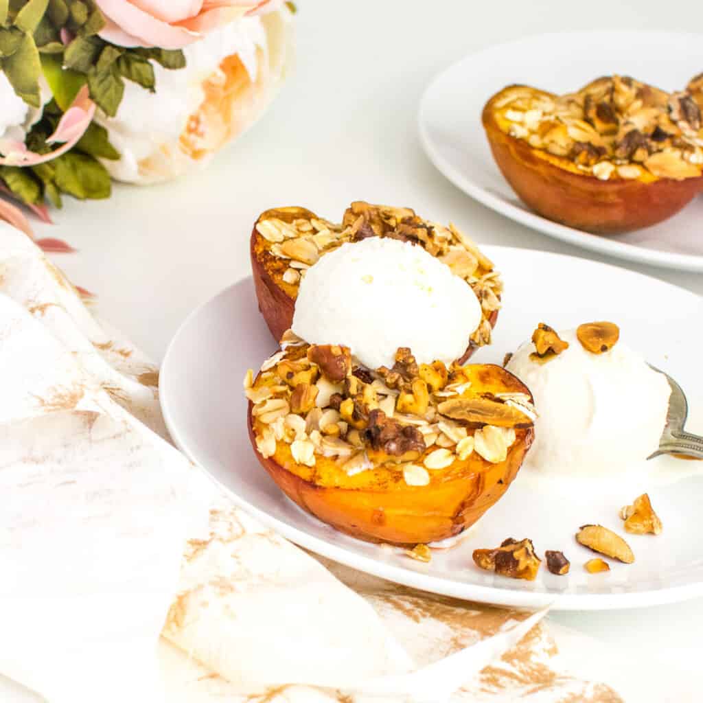 a front view of air fryer peaches served with ice cream. 