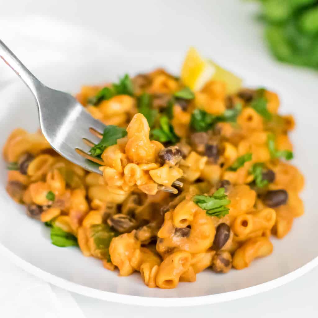 a fork picking up chipotle pasta for a close up view. 