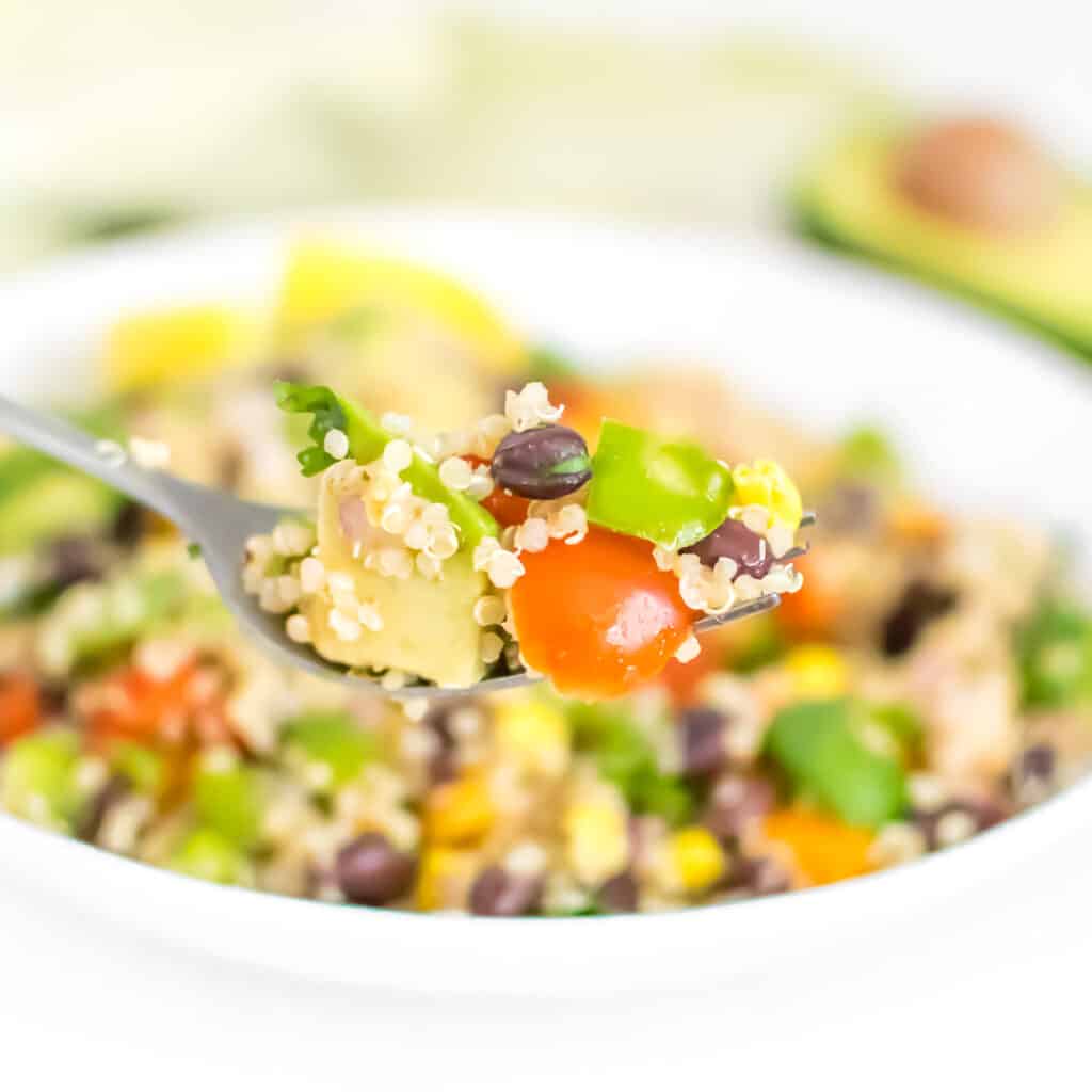 a fork picking up Mexican quinoa salad. 