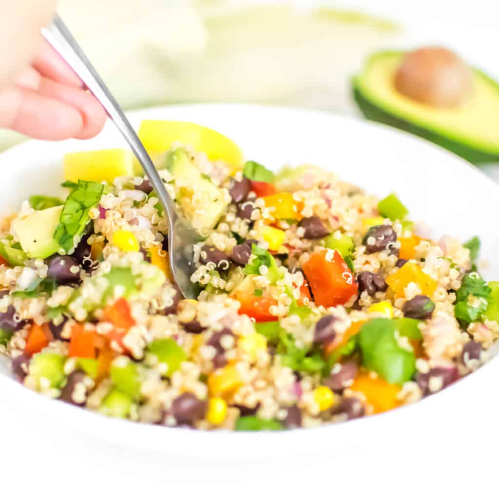 a fork digging into Mexican quinoa salad.