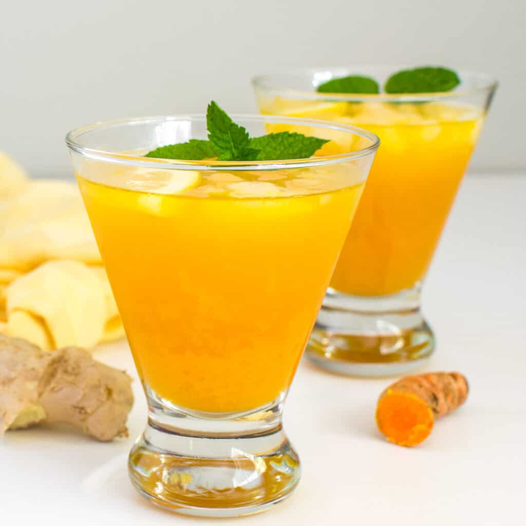 a front view of glasses filled with turmeric ginger lemonade. 