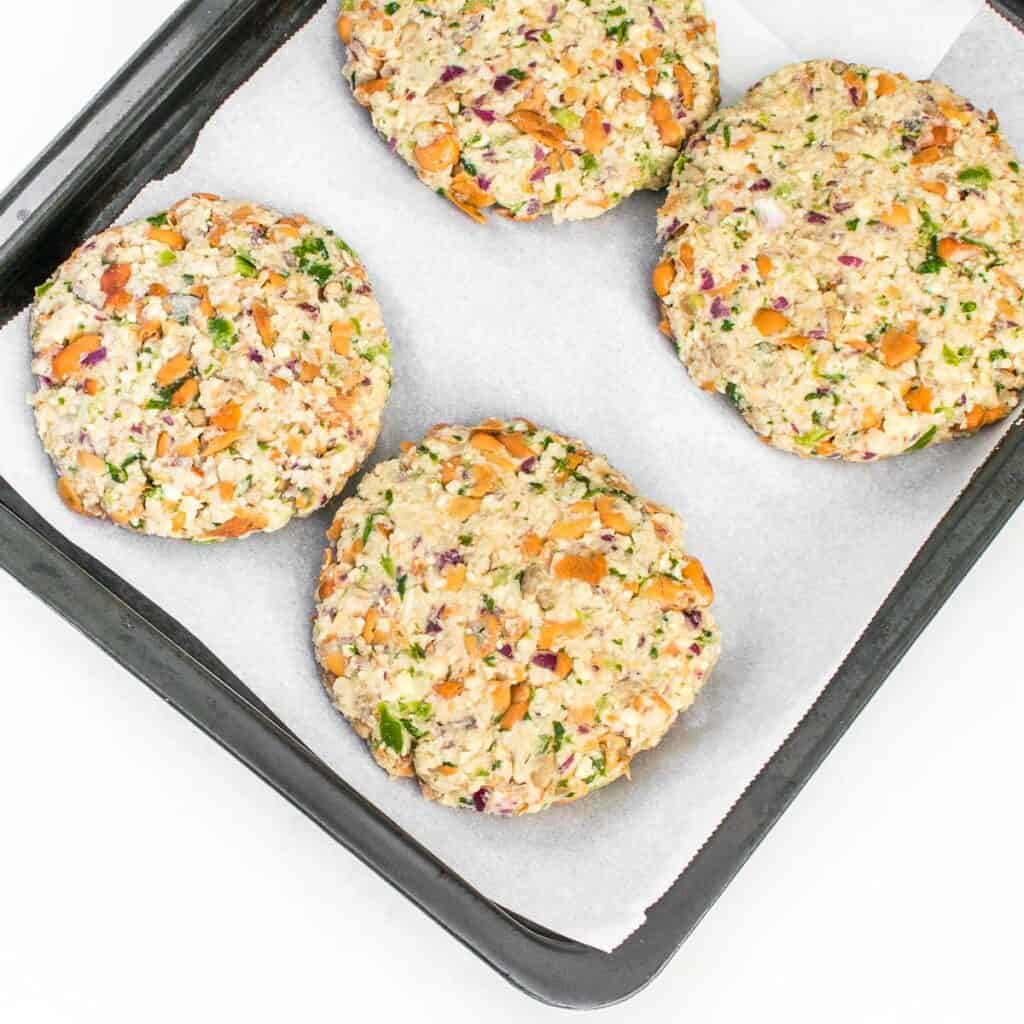 round patties on a baking sheet ready to bake. 