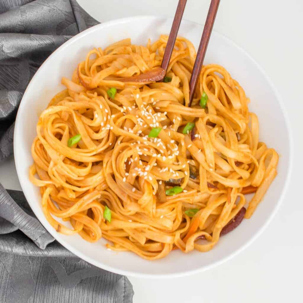 top view of served gochujang noodles with chopsticks. 