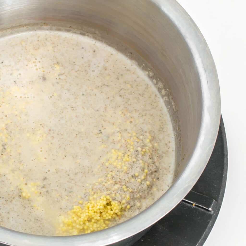 millet stirred into the milk in the saucepan. 