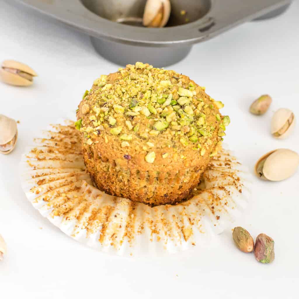 a close up view of the unwrapped pistachio muffins.
