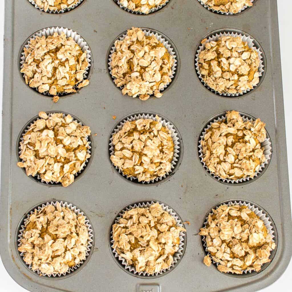 top view of baked vegan pumpkin muffins in the tray. 