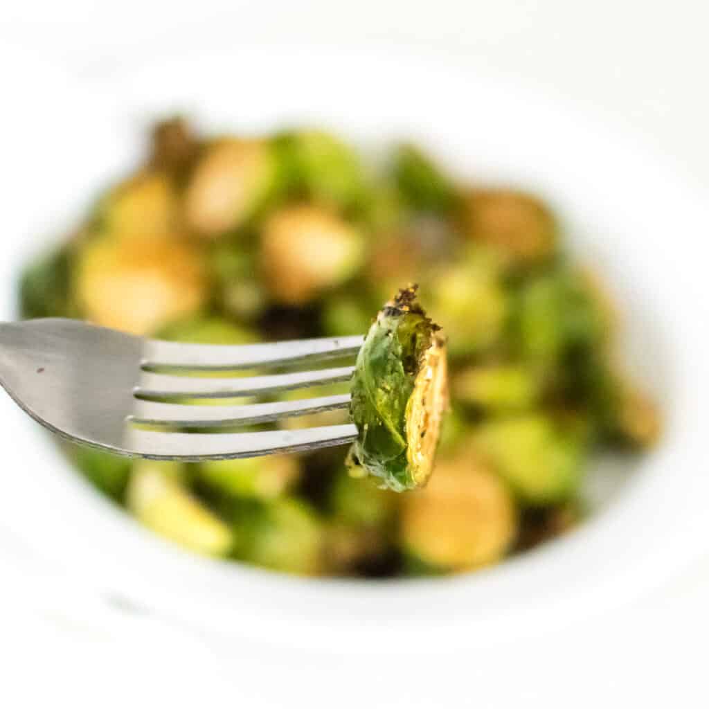 one of the air fryer brussels sprouts picked up in a fork. 