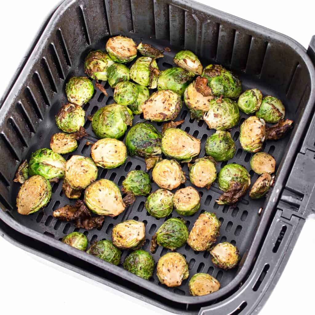 cooked brussels sprouts in the air fryer basket. 