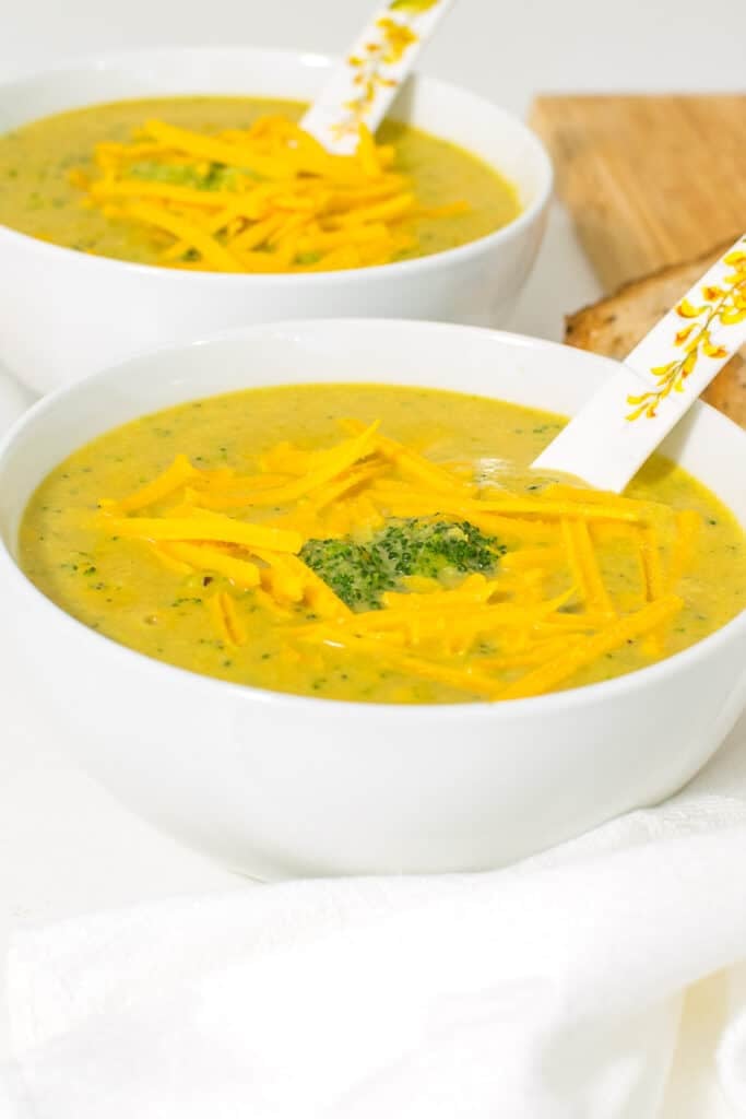 a front view of the serving bowls with vegan broccoli cheddar soup. 