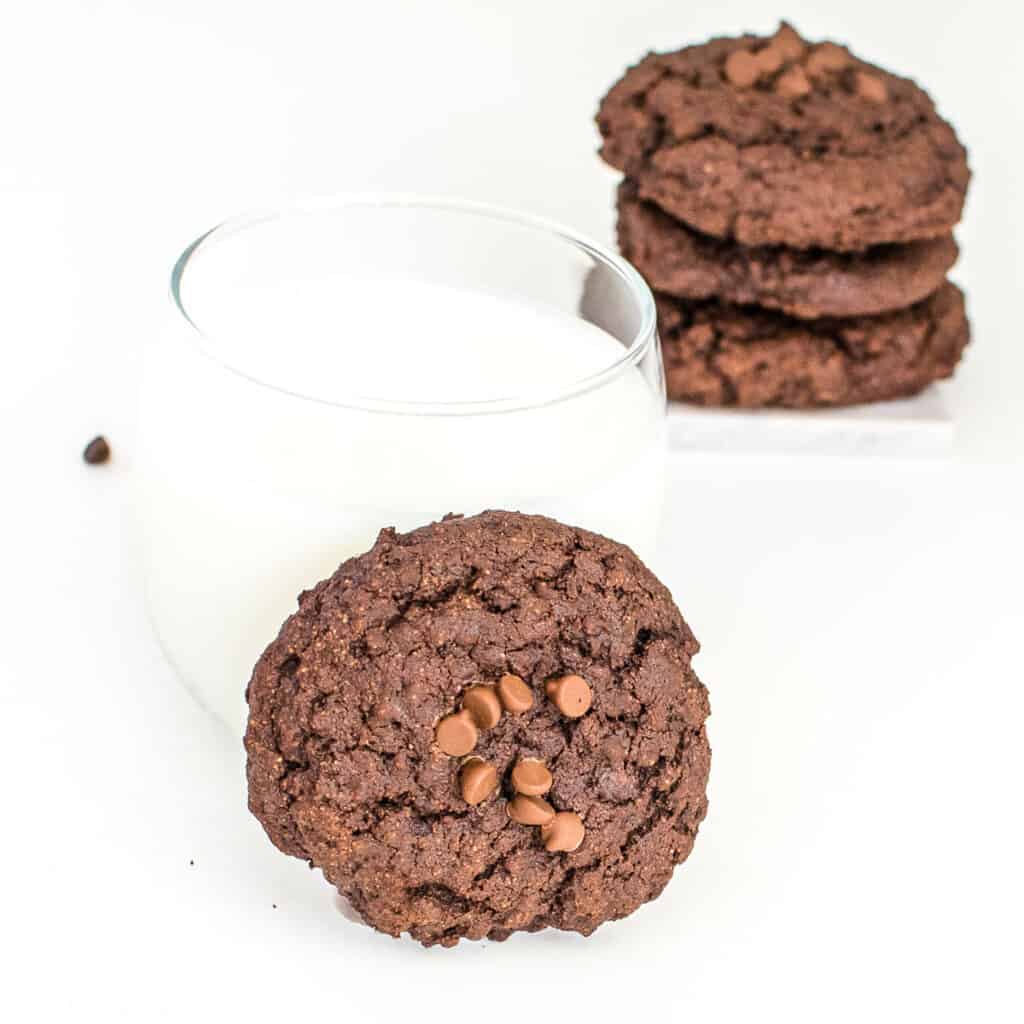 front view of one of the vegan chocolate cookies with the milk glass. 