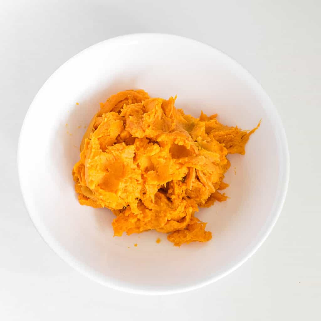 mashed sweet potato in a mixing bowl. 