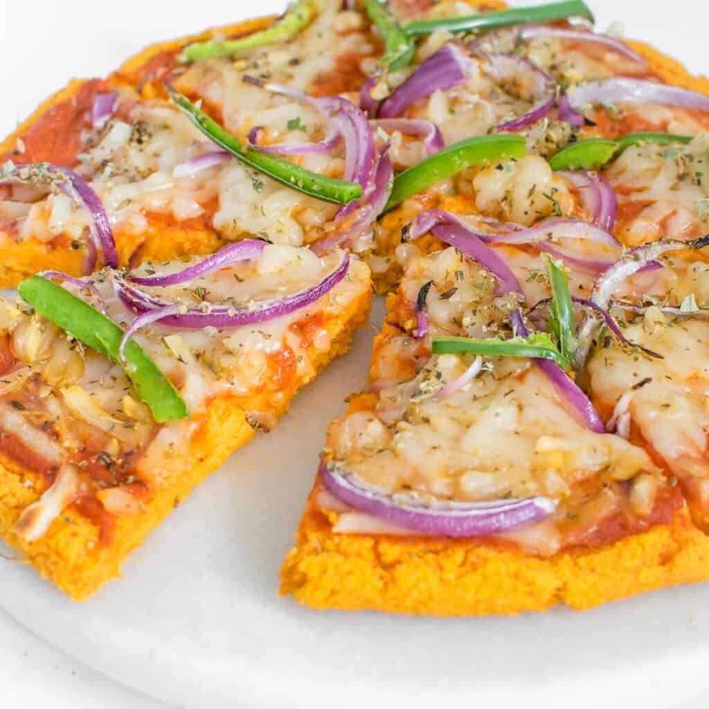 side angle view of the whole sweet potato pizza crust sliced.