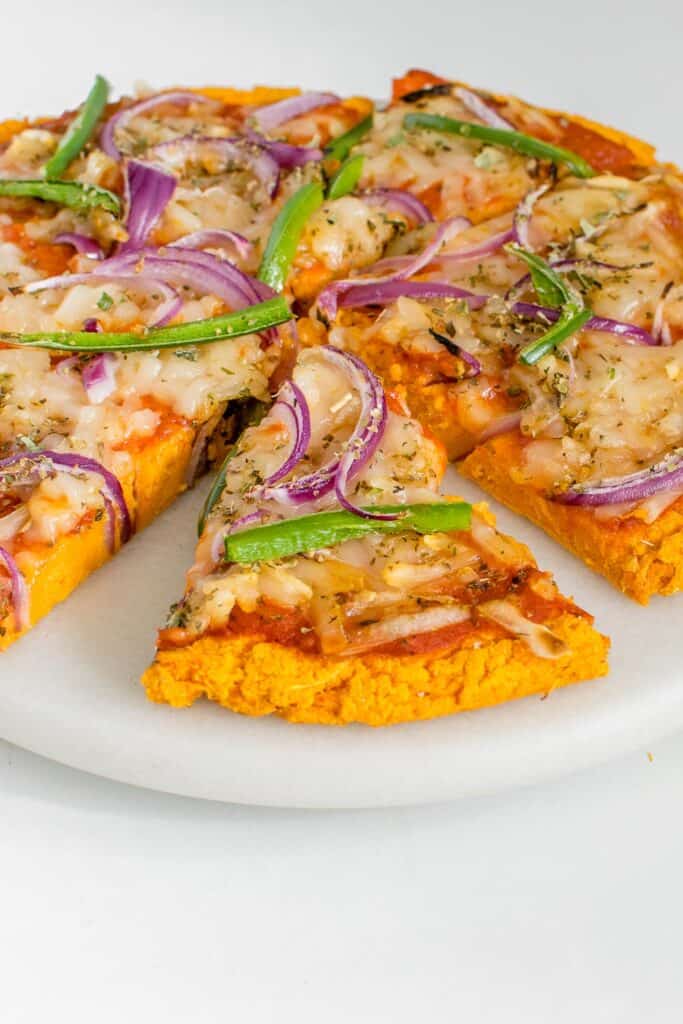 a front view of sliced sweet potato pizza crust. 