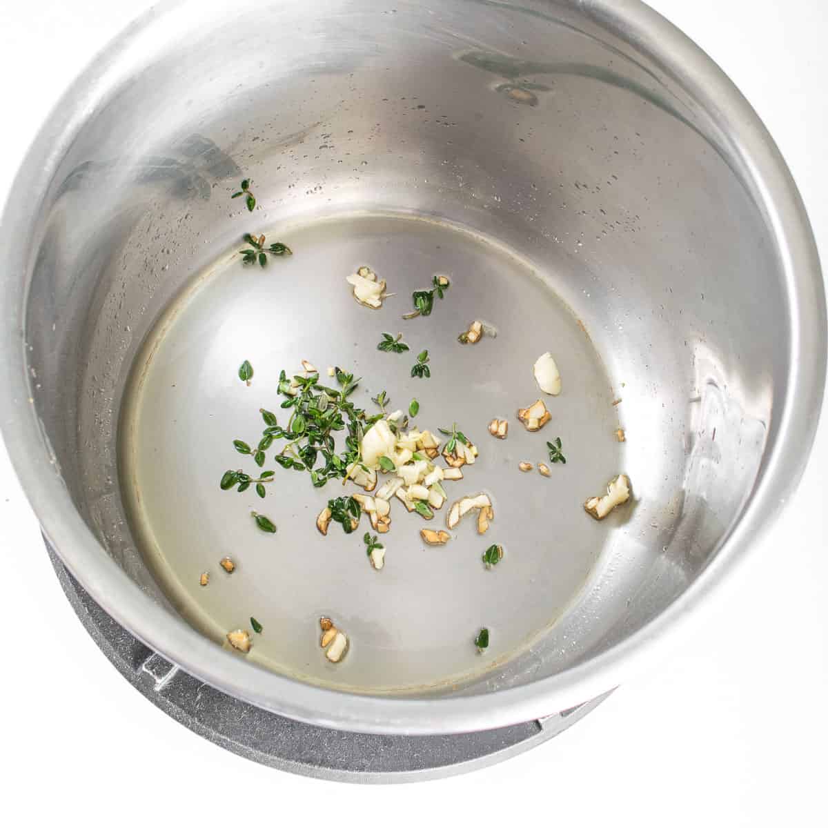 herbs cooked in oil in the instant pot.
