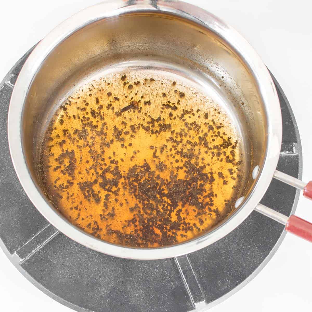 tea brewing with the spices in the saucepan. 