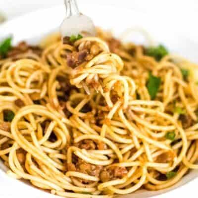lentil Bolognese mixed in spaghetti and picked with a fork.