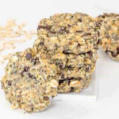 stacked vegan no bake protein cookies with one cookie in its front.