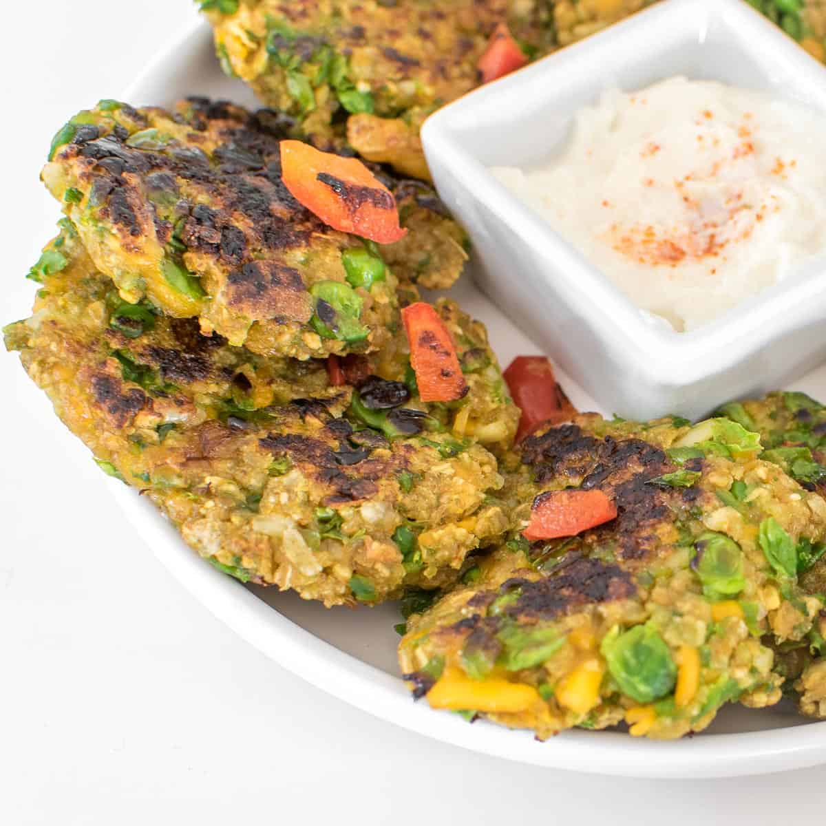 close up view of served green pea fritters. 