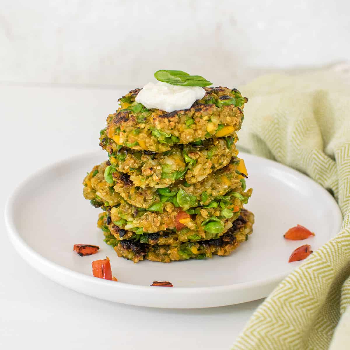front view of stacked green pea fritters