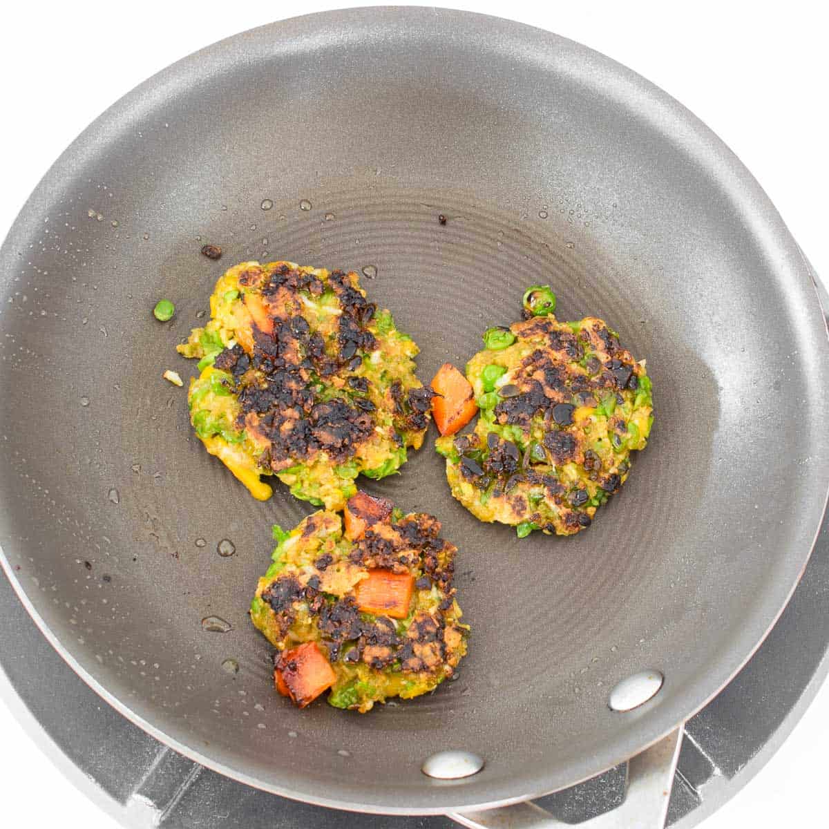 cooked green pea fritters in the pan. 