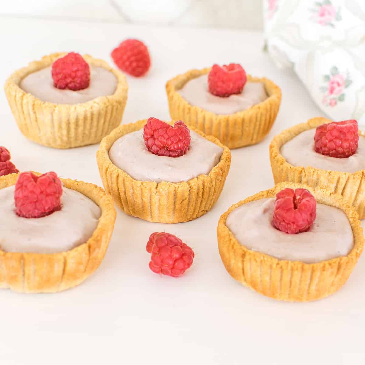 a 45 degree angle view of all the mini raspberry cream tarts. 