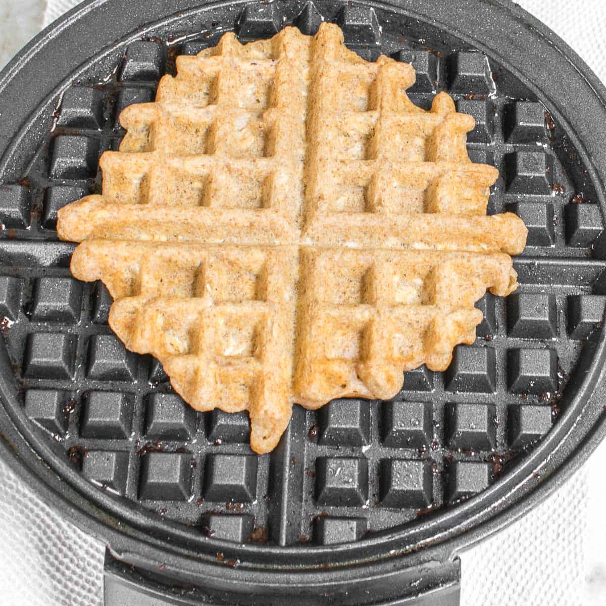 cooked waffle in the waffle maker. 