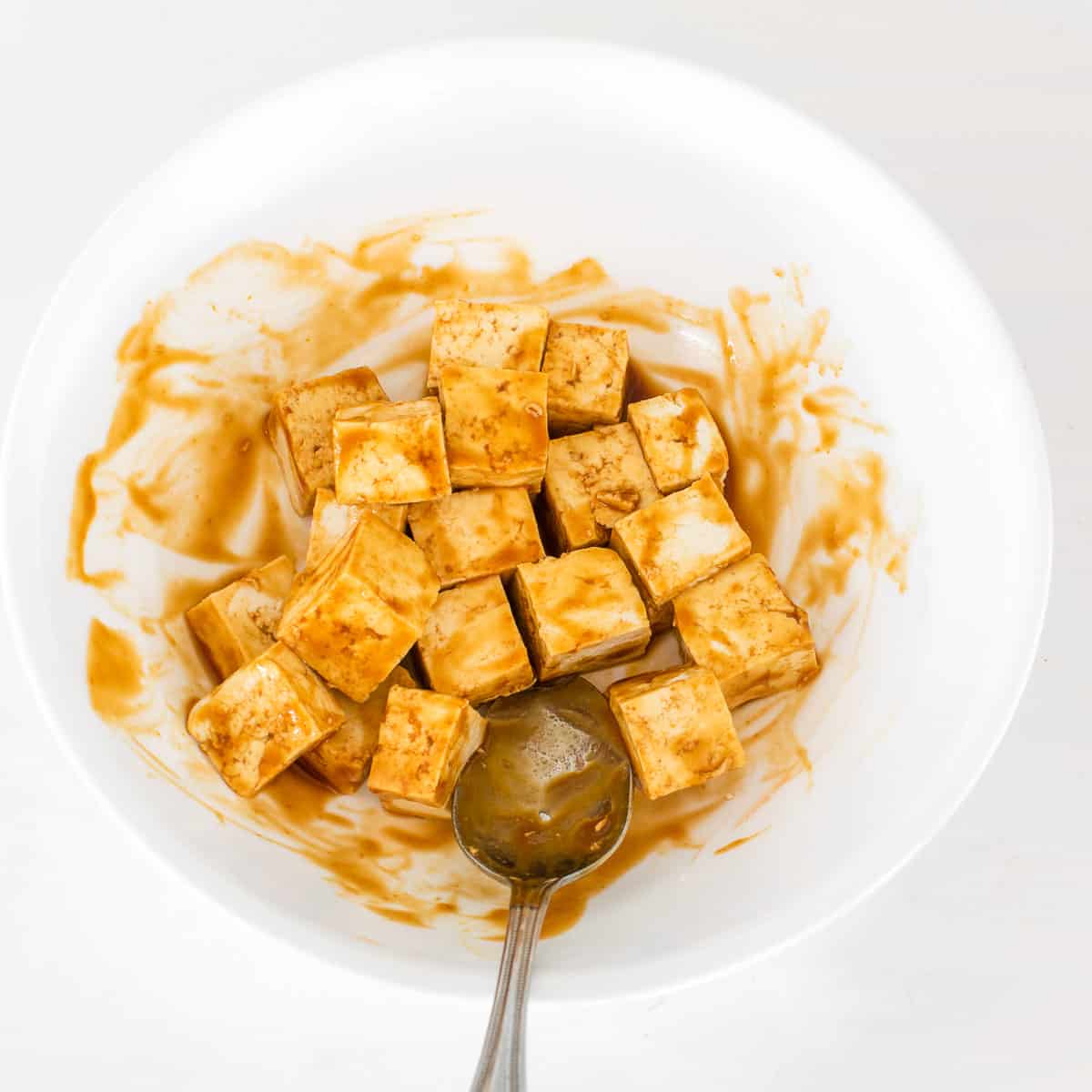 tofu pieces marinated in the mixing bowl. 