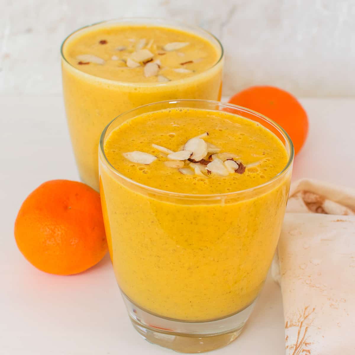 front view of served orange smoothie. 