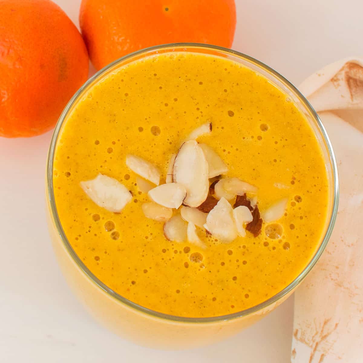 top view of orange smoothie in a serving glass. 