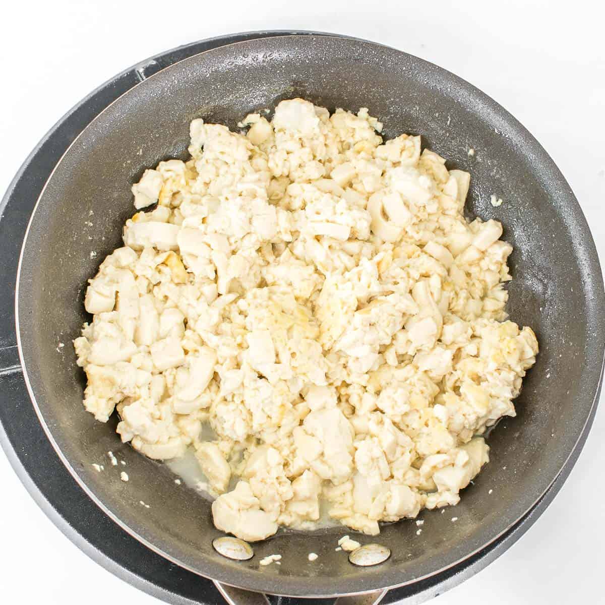 sauteed silken tofu in a pan. 