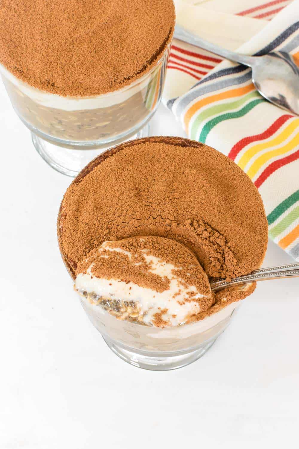 top view of a spoon digging out from a bowl of served tiramisu overnight oats.