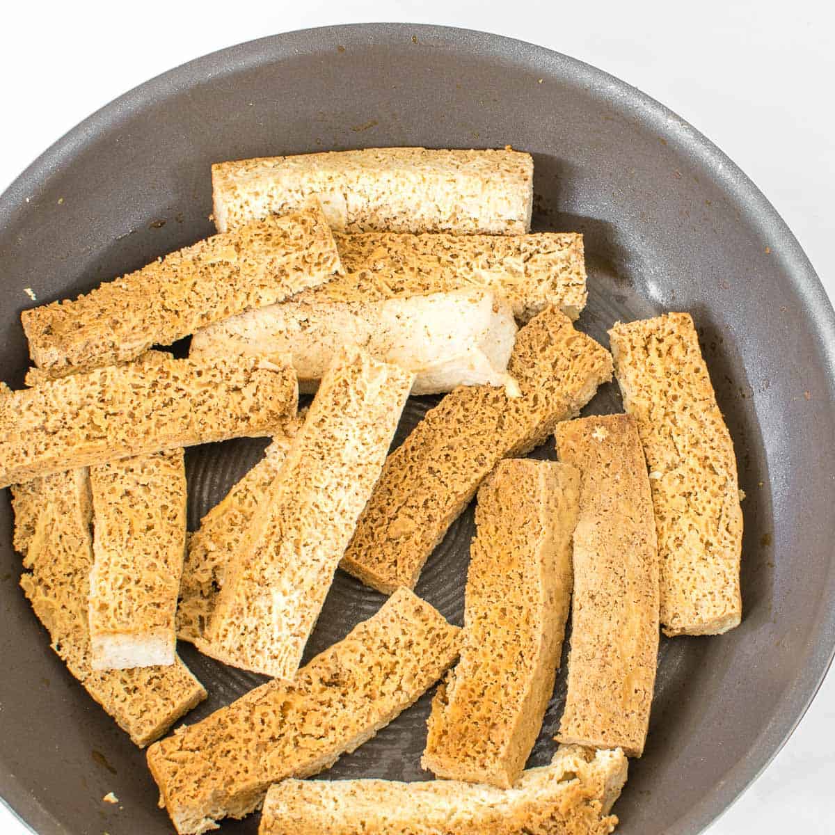 sauteed tofu in a nonstick pan. 