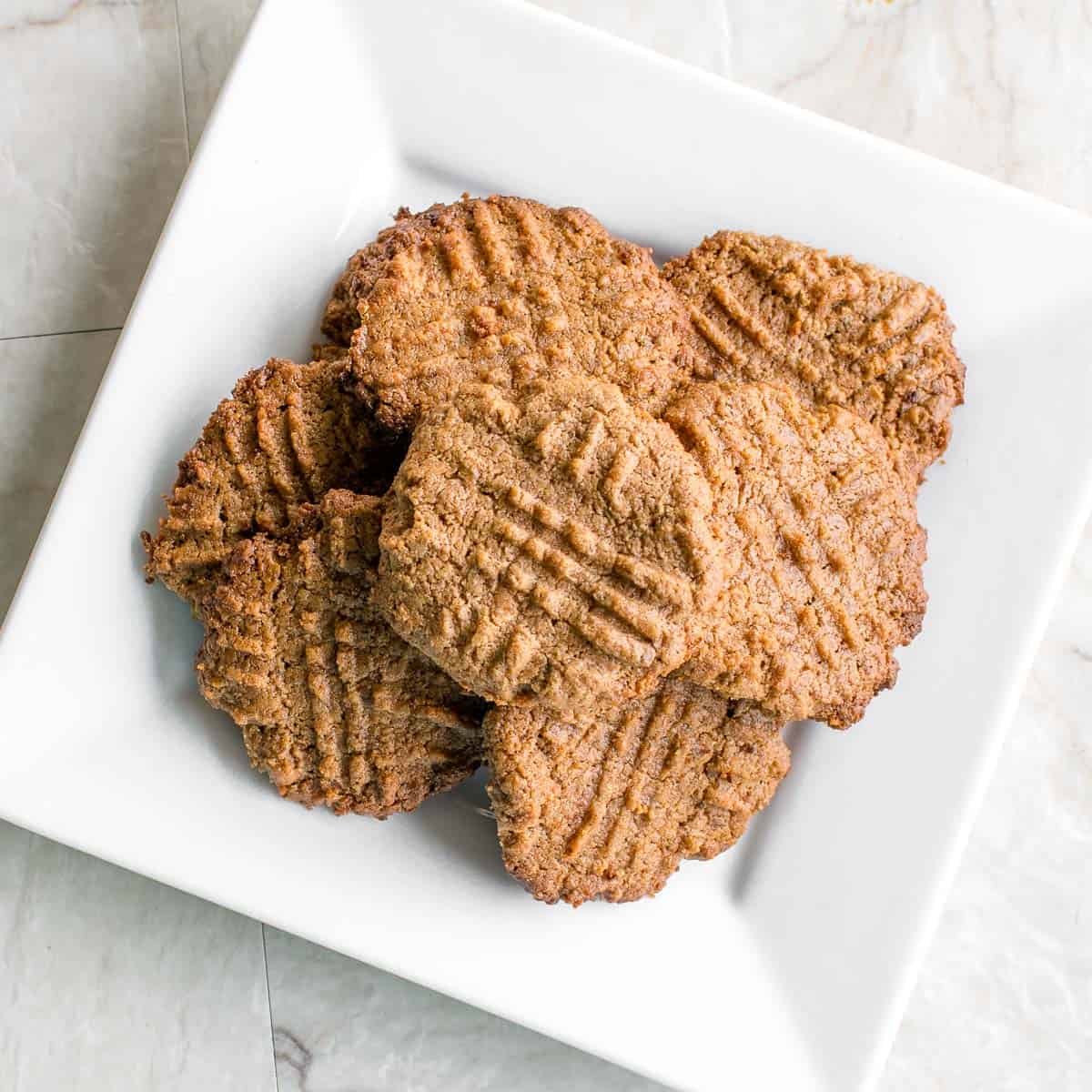 top view of vegan almond butter cookies loaded in a plate.