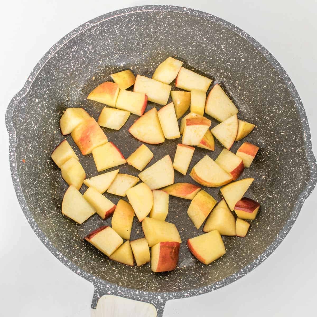 sauteed apples in a pan.