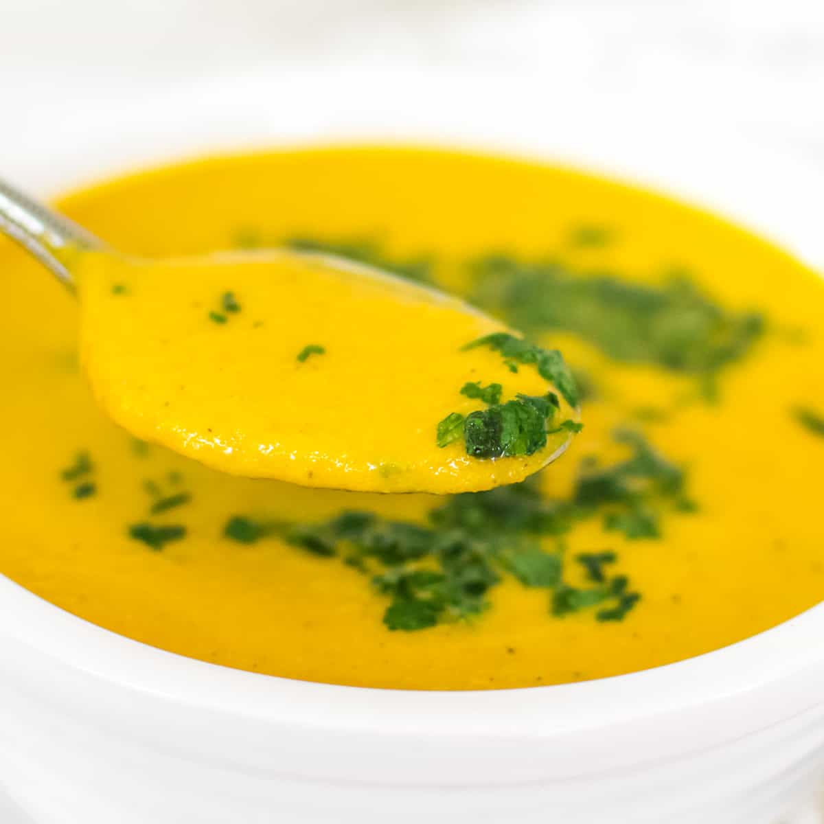a spoonful of soup in focus.