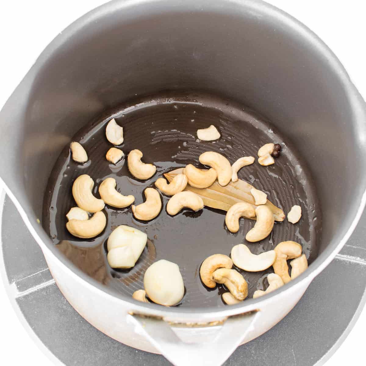 whole spices and cashews sauteed in oil in the stockpot.