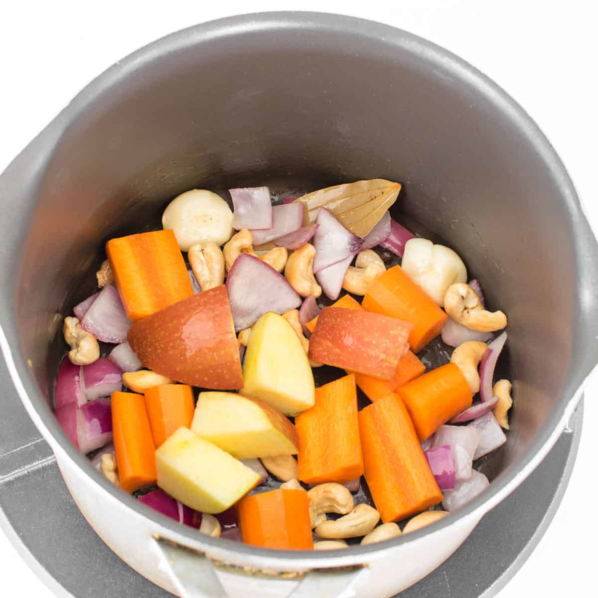 carrot and apples being cooked in the stockpot.