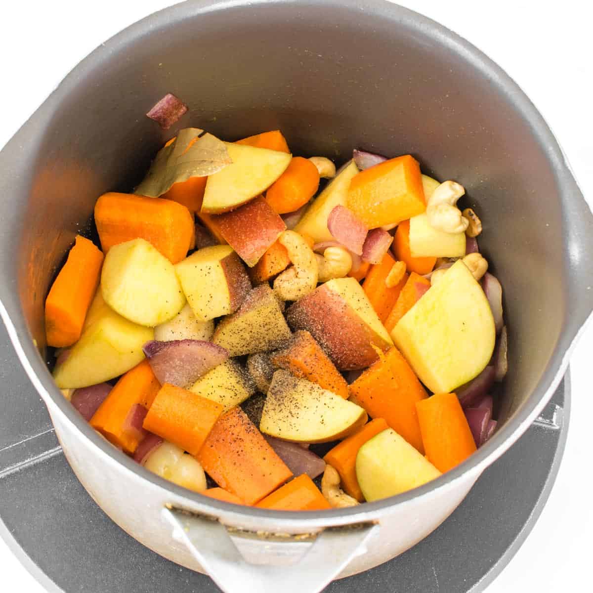 seasoned fruit and vegetables being cooked in the stockpot.