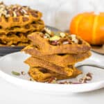 a front view of sliced and stacked vegan pumpkin waffles.