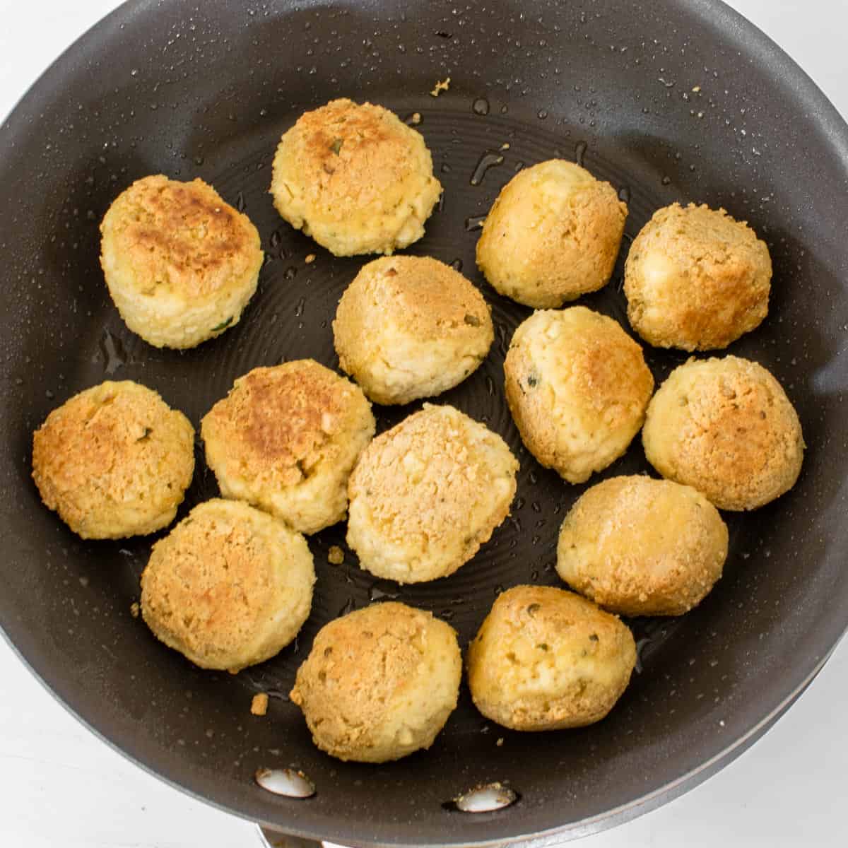 cooked meatballs in a nonstick pan.